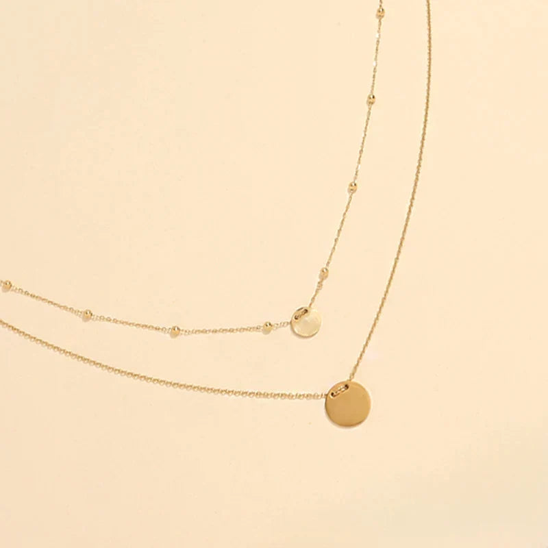 Collier Amani doré à double chaîne et médailles