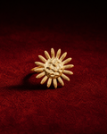 Bague soleil dorée ajustable sur fond rouge signature Amani by Layal